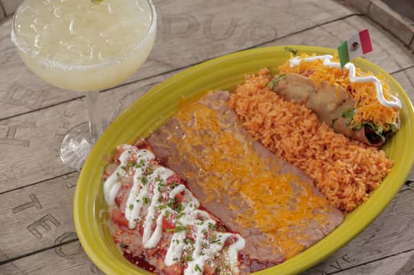 combo number five, an cheese enchilada topped with crema and a tinga taco with a side of rice and beans.
