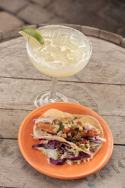 Tecate fish taco topped with mango salsa and baja sauce. Served along side a Cien-A-Rita.