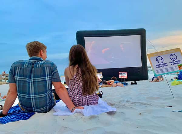 couple watching movie on the beach