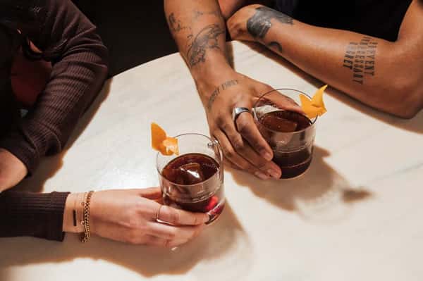 Two hands holding glasses of wine