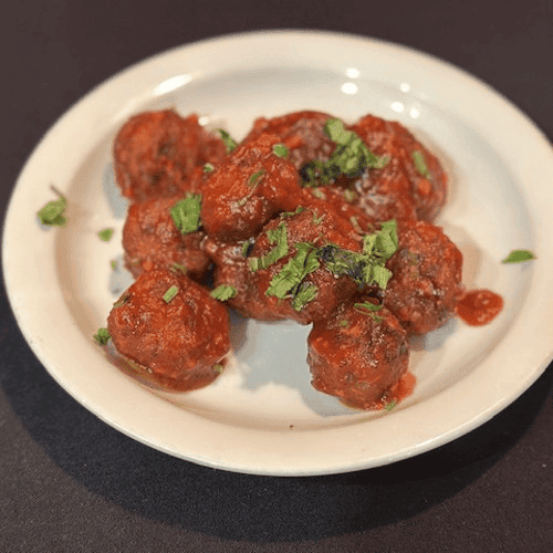 Kebab curry served on a plate and garnished with coriander