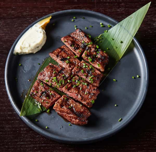 sliced beef served over leaf garnish