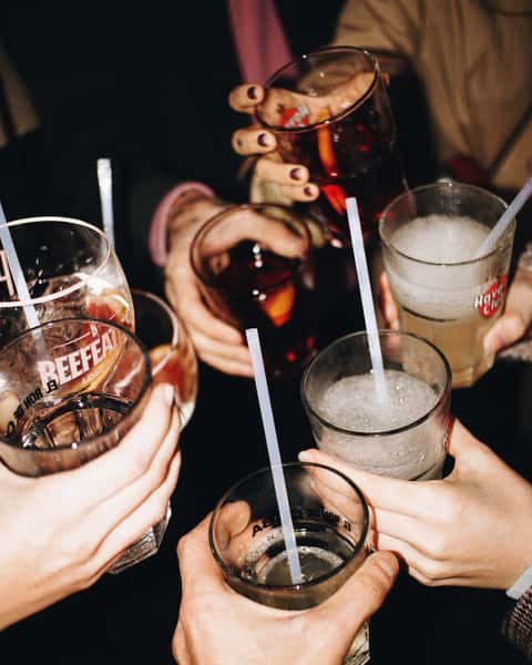 toasting glasses of cocktails and beer