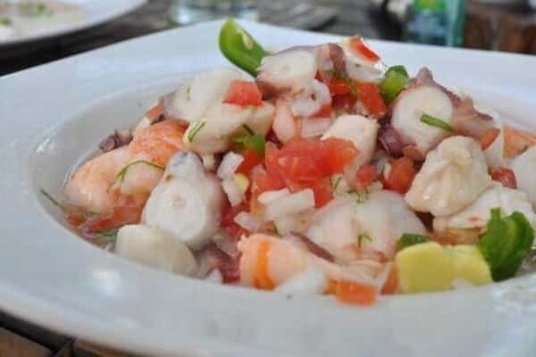 Ceviche de Camaron (Shrimp): Precooked salad size shrimp marinated in lemon juice, mixed with onions, jalapenos. cilantro, tomatoes and garnished with avocado. served with saltine crackers