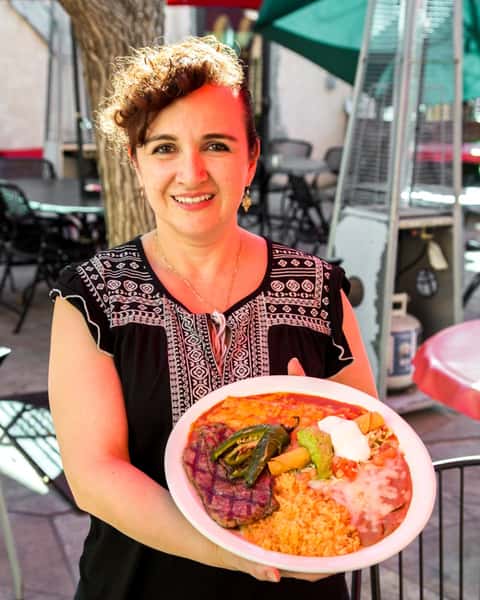Carne Tampiquena: New York steak grilled to perfection with cheese enchilada and a flauta topped with guacamole and crema. Served with chile asado, beans, and rice