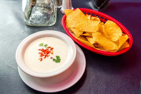 Chile con Queso Dip: White cheese melted with jalapenos. Served with chips