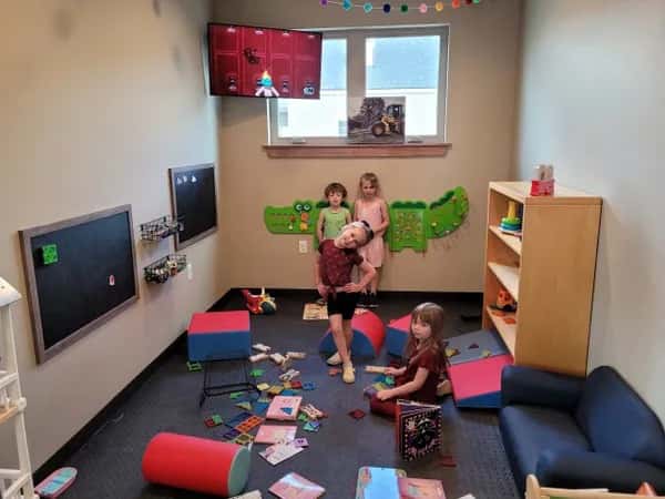 Kid-friendly playroom at Otto's Landing featuring soft seating, educational wall activities, and a variety of toys, offering a family-friendly dining experience.