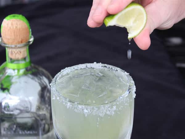 margarita with bottle of tequila in the background