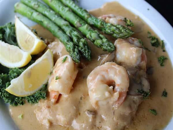 chicken breast topped with grilled shrimp in a cream sauce