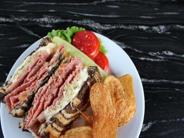 reuben sandwich with a side of chips