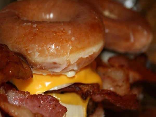 Cheeseburgers with onionsand bacon wtih glazed donuts as buns