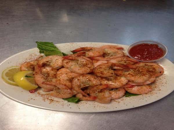 steamed seasoned shrimp with a side of cocktail sauce