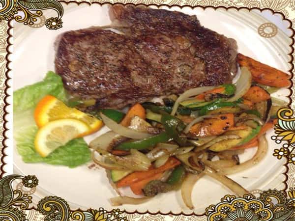 perfectly cooked steak with a side of fresh steamed vegetables