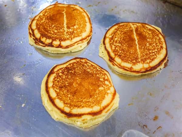 three pancakes on the griddle