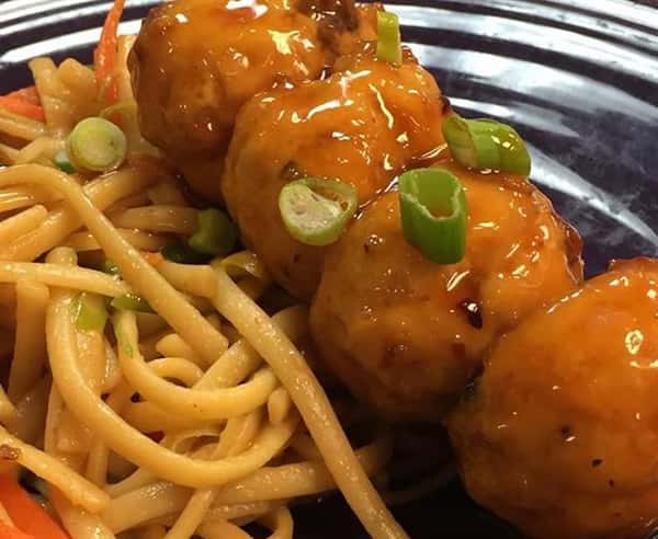 four meatballs with a side of pasta