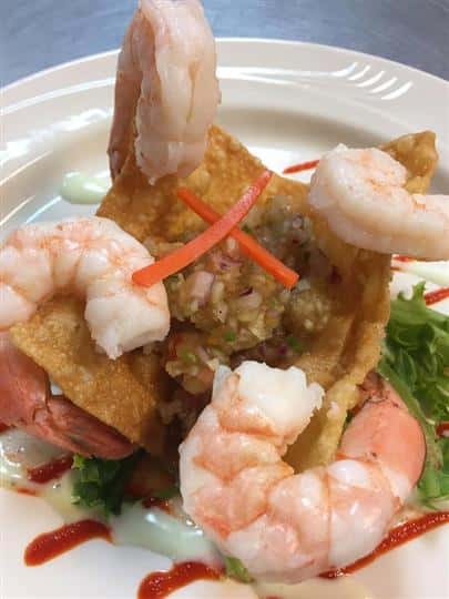 fried wonton with four shrimp on a bed on lettuce