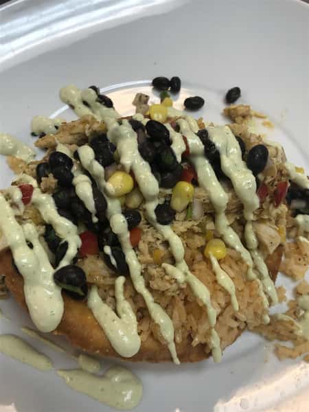 rice with black beans, corn, red pepper and white sauce drizzled