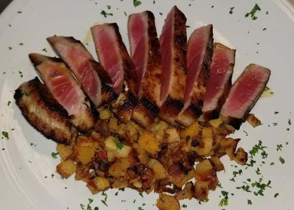 nine slices of ahi tuna with a side of diced potaotoes