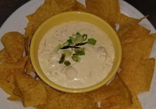 nachos with a side of nacho cheese dip
