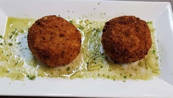 two riceballs on a white plate