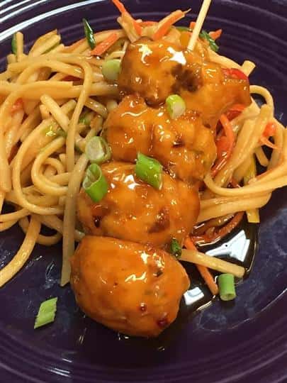 four meatballs with a side of pasta