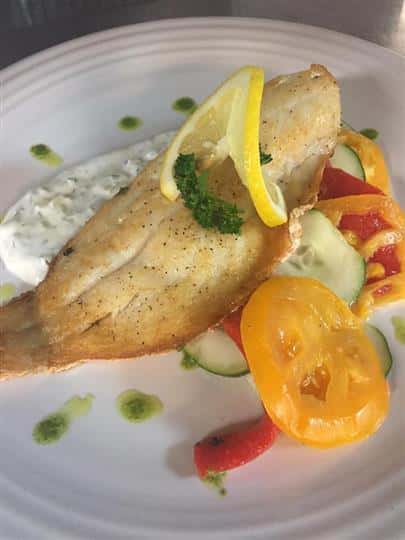 a potato chip with mixed vegetables on a white plate