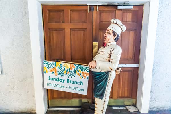 Chef statue holding sign for Sunday Brunch