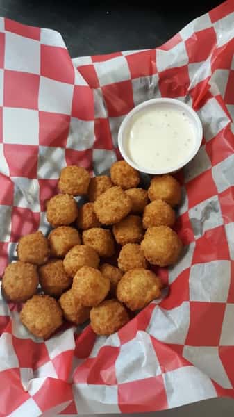 assortment of cheese curds and dipping sauce