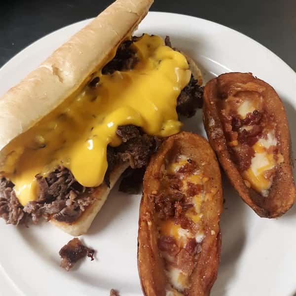 philly cheesesteak with a side of baked potatoes