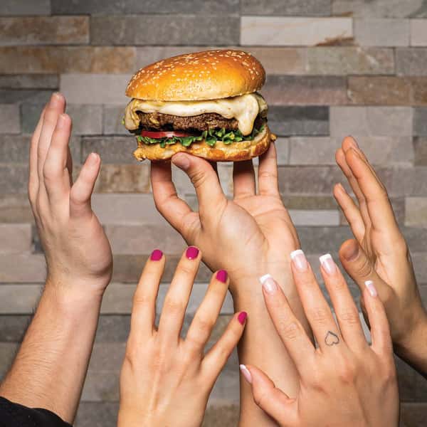 hands holding up cheeseburger