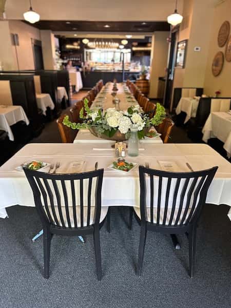 Private dining room banquet setup with elegantly arranged tables for special events at Serafini in historic downtown Frankfort, Kentucky.