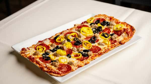 House-made flatbread pizza topped with pepperoni, olives, banana peppers, and melted cheese at Serafini in downtown Frankfort, Kentucky.