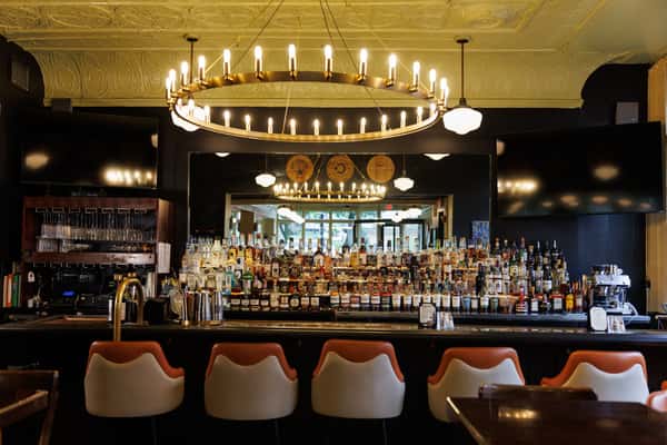 Elegant bar and dining area at Serafini featuring a full-service cocktail bar and warm, inviting atmosphere in downtown Frankfort, Kentucky.