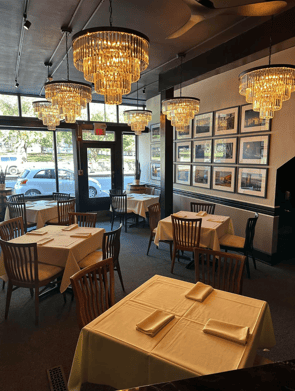 Private dining room banquet setup with elegantly arranged tables for special events at Serafini in historic downtown Frankfort, Kentucky.