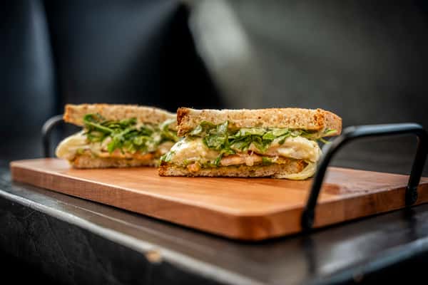 basil pesto on top of a wooden plate on a table
