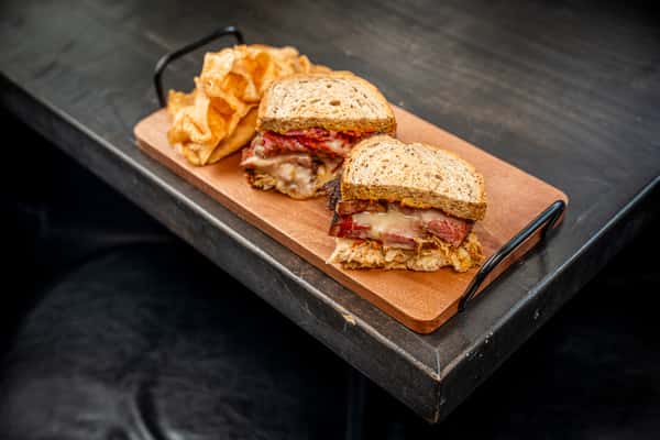 roast beef on top of a wooden plate on a table