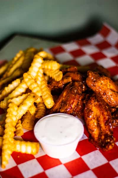 close up of wings and fries