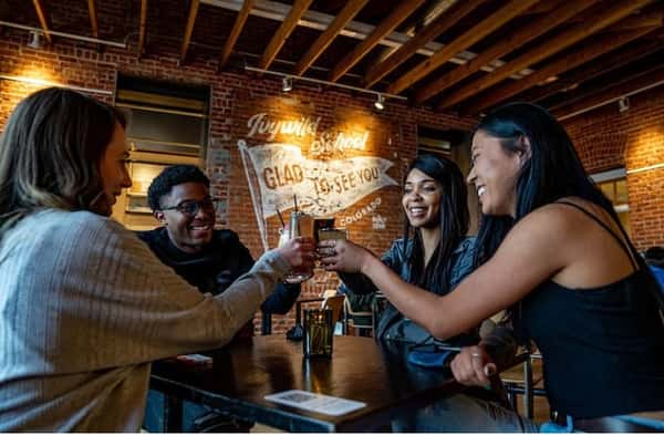 Raising a toast at Bristol Brewing in Ivywild School with the Crafts and Drafts Passport, a free program of Visit Colorado Springs that provides discounts, deals and cheap drinks all around town. Photo by Gray Filer Photography.