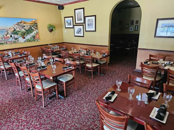 Warm and inviting Italian dining room with table seating at Positano Ristorante Italiano