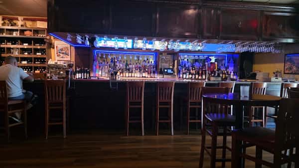 Elegant cocktail bar with blue accent lighting inside Positano Ristorante Italiano in Palm Harbor