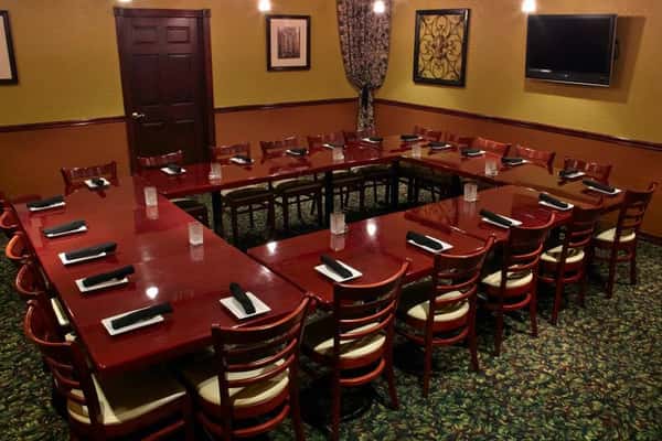 Private dining room with long banquet table setup at Positano Ristorante Italiano in Palm Harbor