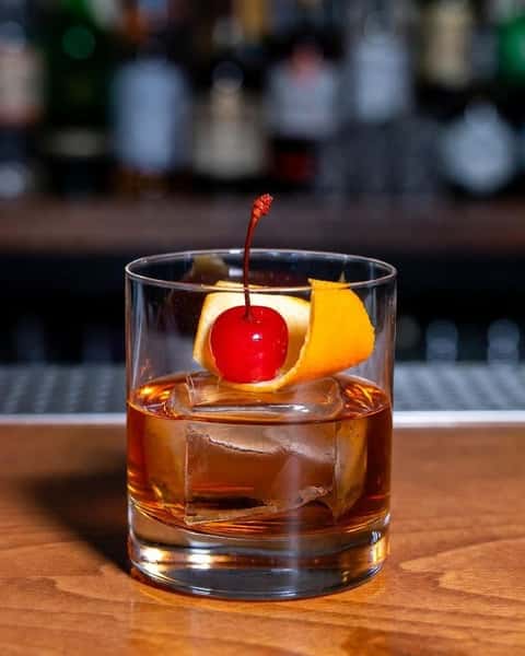 Classic old fashioned cocktail with cherry garnish served at Positano Ristorante Italiano