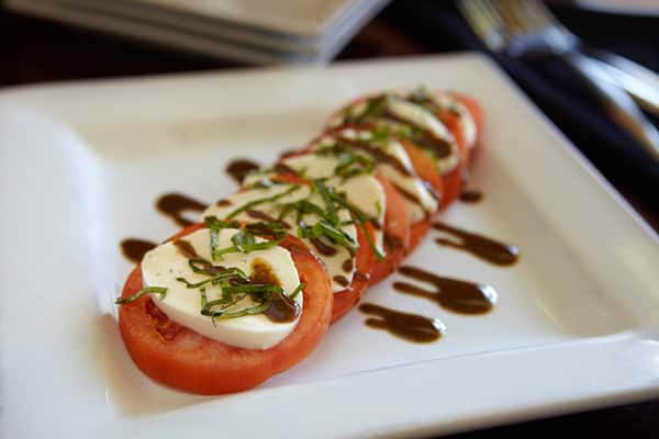 Fresh caprese salad with mozzarella, tomatoes, basil, and balsamic glaze at Positano Ristorante Italiano