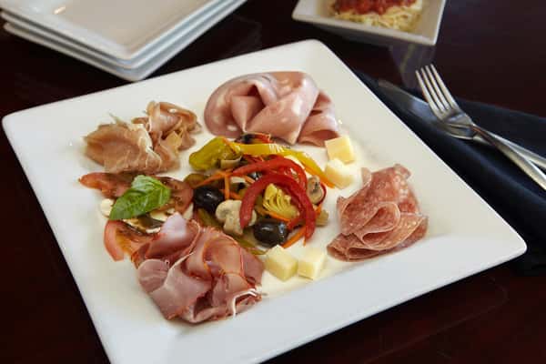 Italian antipasto plate with cured meats, roasted peppers, and fresh mozzarella at Positano Ristorante Italiano