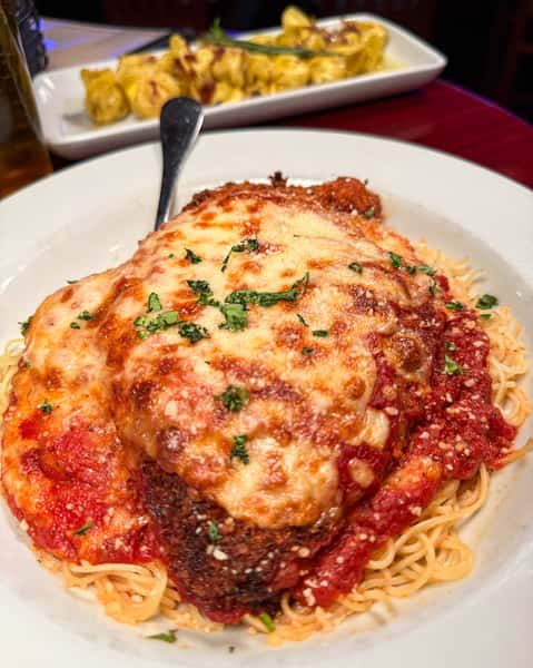 Classic chicken parmigiana with melted mozzarella and marinara sauce at Positano Ristorante Italiano