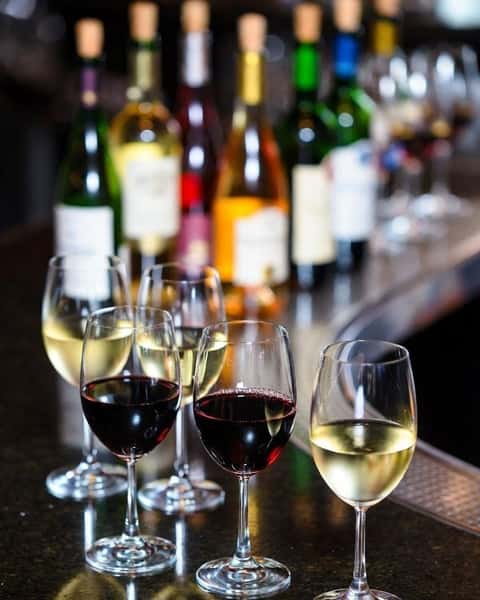 Wine glasses and bottles displayed at the upscale Italian dining bar at Positano Ristorante Italiano