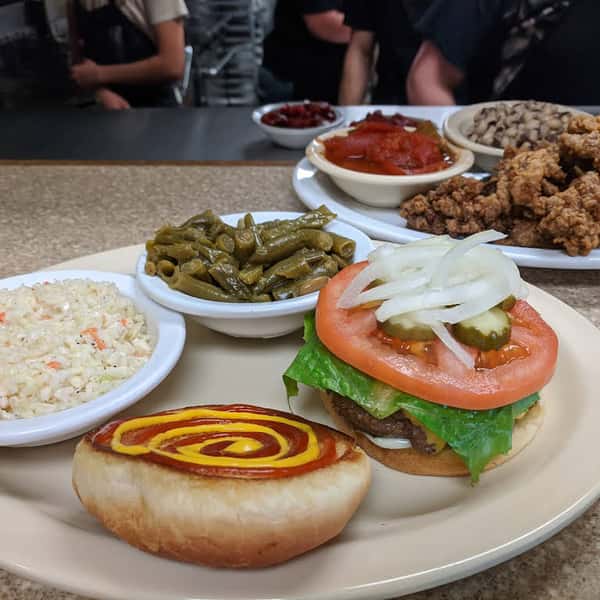 Freshly prepared burger with sides