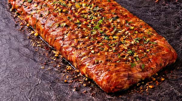 Marinated beef skirt steak seasoned with herbs and spices for grilling