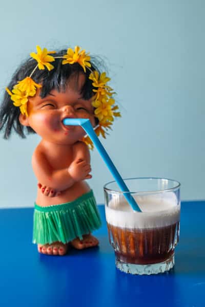 Hawaiian theme figurine sipping on a drink