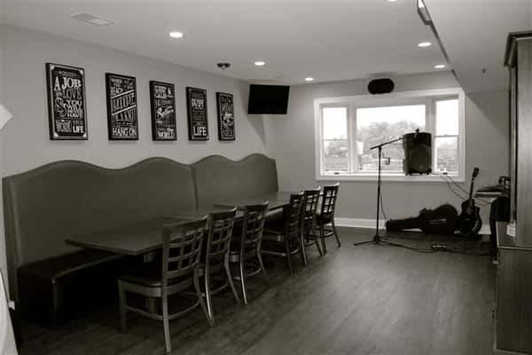 black and white photo of round tables and chairs in the dining room